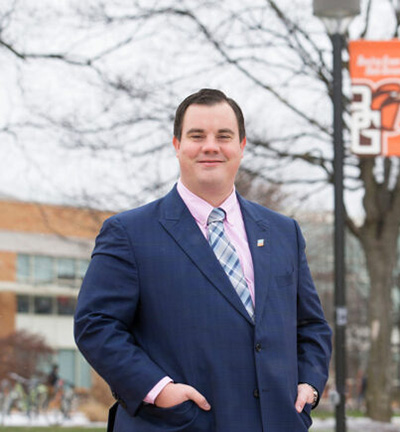 Dr Ardy Gonyer standing in front of BGSU in a blue suit.