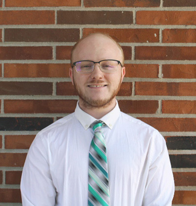 Nate Watson, Vice President of ZiggyZooms, standing in front of a brick wall.